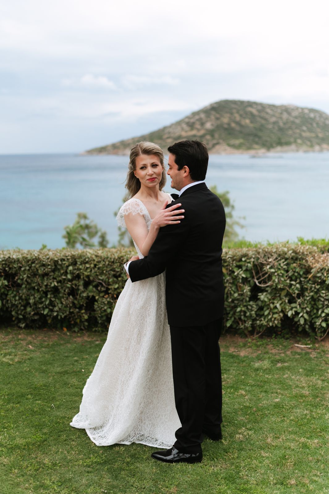 Couple embracing on the lawn above the sea at Ktima 48, Athens Riviera